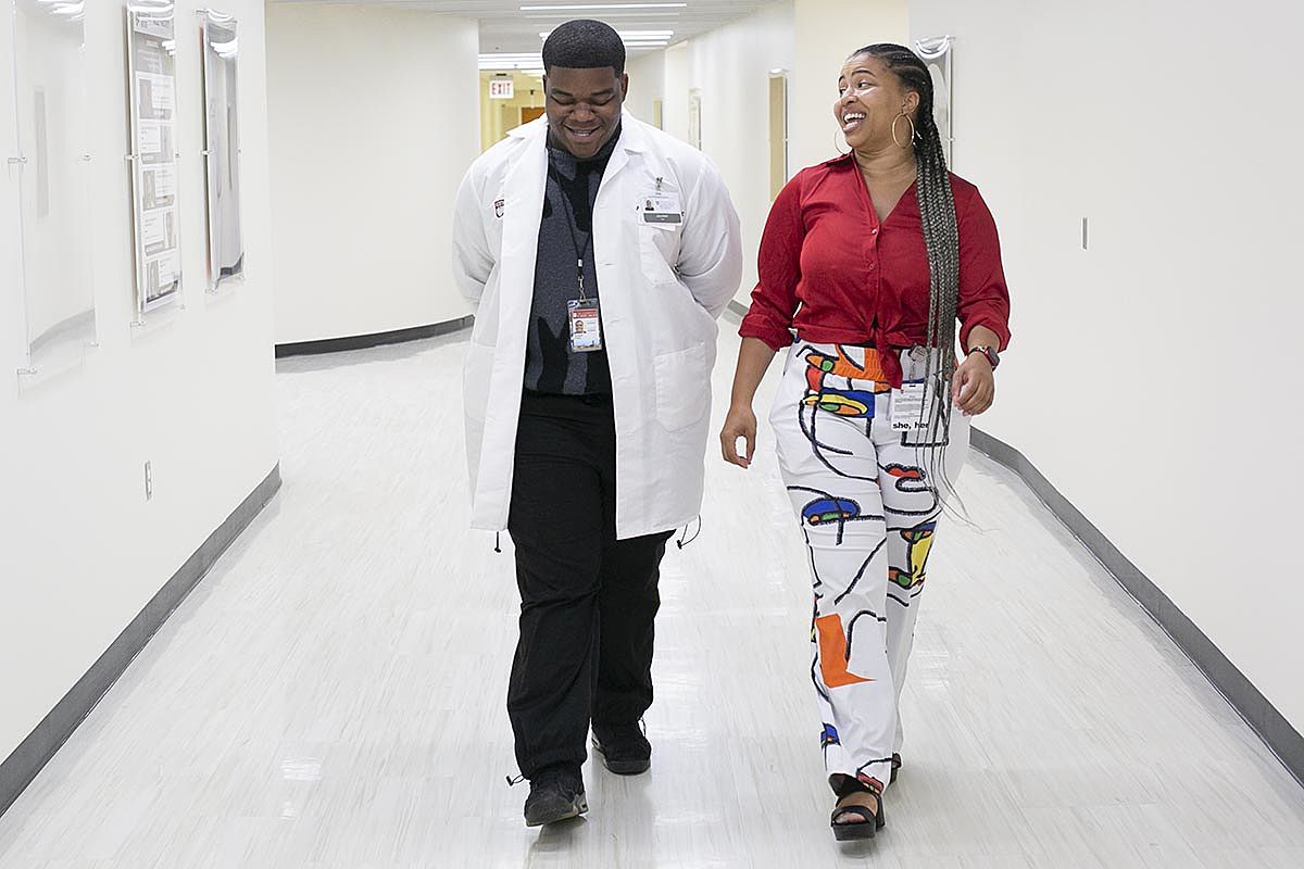 Lewis and Harrison walk through UChicago Medicine hallway during this summer's Youth Internship Program experience