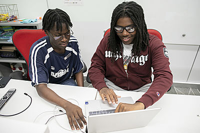 Nasir Hardaman reviews Python coding project with one of the UChicago students working in the CISL lab