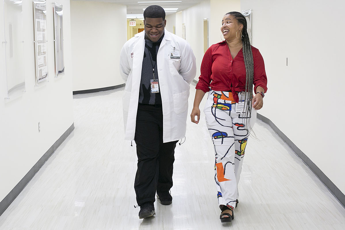 Jayden Lewis, a 2nd year YIP student checks in with one of his staff mentors Briana Harrison