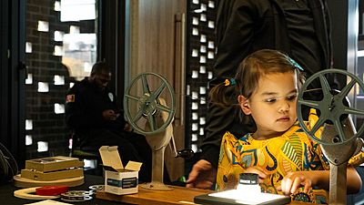 A young participant learns about film archiving at Home Movie Day, an annual event hosted by the SSHMP where donor families' home movies are publicly screened and celebrated.