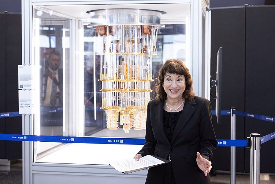UChicago Pritzker School of Molecular Engineering (UChicago PME) Prof. Nancy Kawalek, founder and director of the Scientists, Technologists, and Artists Generating Exploration (STAGE) Center, speaks at the unveiling of “Imagining the Future: An Encounter with Quantum Technologies,” a public display model of an IBM Quantum System One quantum computer, and an accompanying website – flyquantum.stage.uchicago.edu – created and designed by the STAGE Center’s students. The exhibit will be on display for a year at United's Terminal 1 at Chicago O'Hare International Airport. (Photo by Anne Ryan)